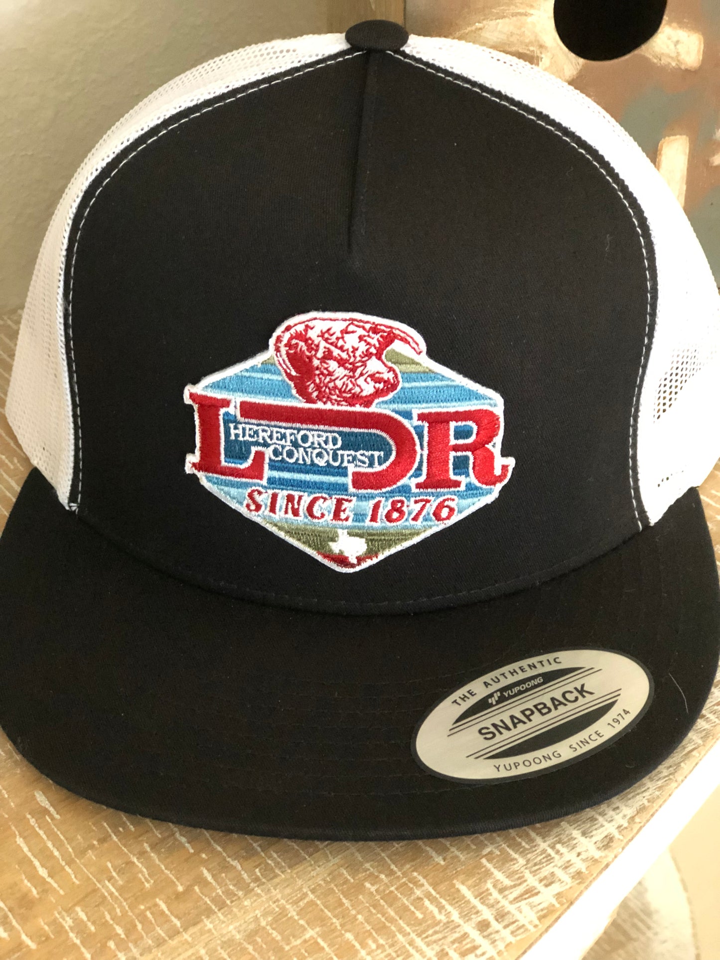 Lazy J conquest black on white cap